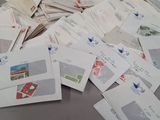 a pile of envelopes sitting on a table next to a pair of scissors