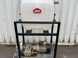 a white tank sitting on top of a metal cart