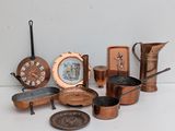 many different types of copper pots and pans on the table