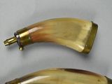 two horns that are sitting next to each other on a table