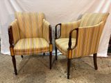 pair of striped upholstered chairs with wood legs and arms
