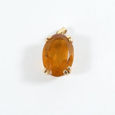 an image of a ring with a large orange stone on it