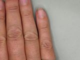 a person ' s hand with a diamond ring on it