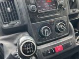 a car dashboard with a steering control and a phone in it