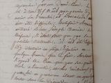 an old book with writing on it sitting on a table