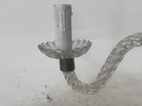 a glass candle holder that is attached to a wall