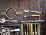 many different types of spoons and forks in a box