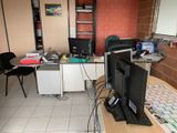 a desk with two computers and a laptop on it