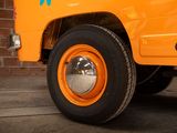 an orange truck that is parked in front of a brick wall