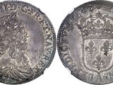 a silver coin with a crown on top of it
