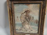an old picture of a man holding a cross in a wooden frame