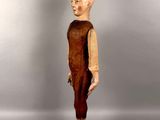 an image of a wooden statue of a man with a bald head