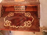 a small desk with a drawer on top of it