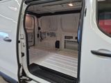 a white van with its doors open in a garage
