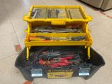 a yellow tool box with tools in it on the floor