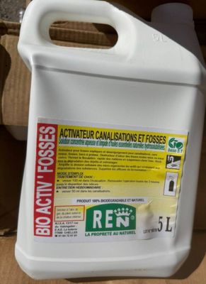 a close up of a bottle of liquid sitting on a cardboard box
