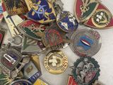 a lot of badges that are laying on a table