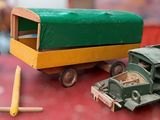three toy trucks and a truck on a red table