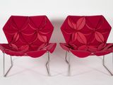 pair of red chairs made out of folded paper on a white surface