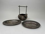 pair of silver plate holders with a cross on top of them