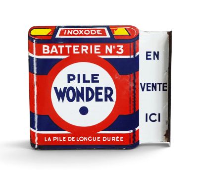 a tin of pill wonder next to a box of cigarettes