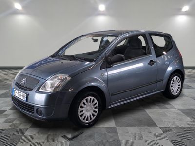a picture of a silver small car parked in a garage