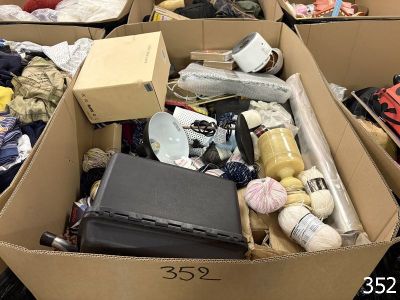 de nombreux cartons de vêtements et d'autres objets dans une pièce