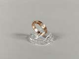 an image of a gold ring on a clear stand
