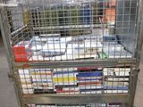 a metal cart with many books on it in a warehouse