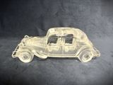 an image of a clear glass model of a car on a black background