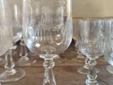 several empty wine glasses sitting on top of a table next to each other
