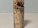 a small silver container with a bird on it