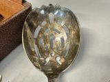 a silver spoon with a design on it sitting on a table