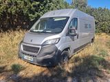 the van is parked on the side of the road in the grass