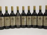six bottles of wine are lined up in a row on a table