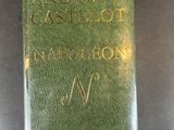 an old green book sitting on top of a black table