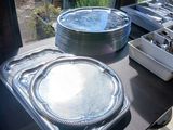 several trays of food are sitting on a table in front of a window