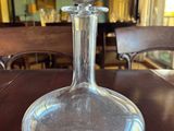 a glass decanter sitting on a table in a restaurant