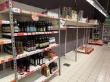 many bottles of beer on the shelves in the store