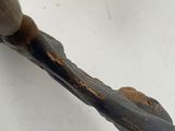 a close up of a metal object on a white surface
