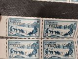 four stamps with a picture of a man on a horse drawn sleigh