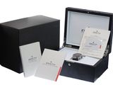 a box with a watch inside of it on a white surface