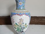 a vase that is sitting on a shelf in a room