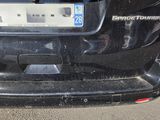 a small black car with a license plate on the back
