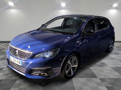 a blue car parked on a checkered floor in a garage