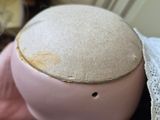 a pink piggy sitting on top of a bed