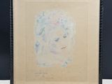 a painting of a woman ' s face is shown in a black frame