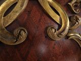 a close up of a clock on a wooden table