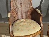 pair of antique cane back chairs with upholstered cushions
