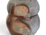 a gray vase with a brown and black design on it